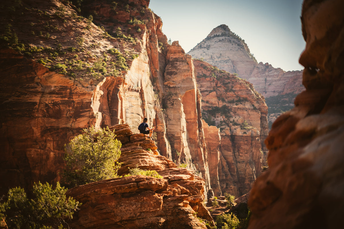 Sandstone cliffs and a distant hiker in Utah