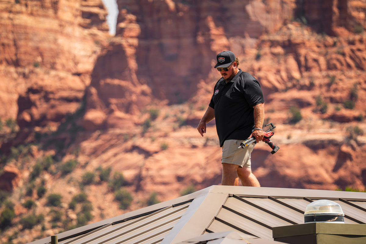 928 Roofing team member working on a roof against the red rock landscape of Sedona