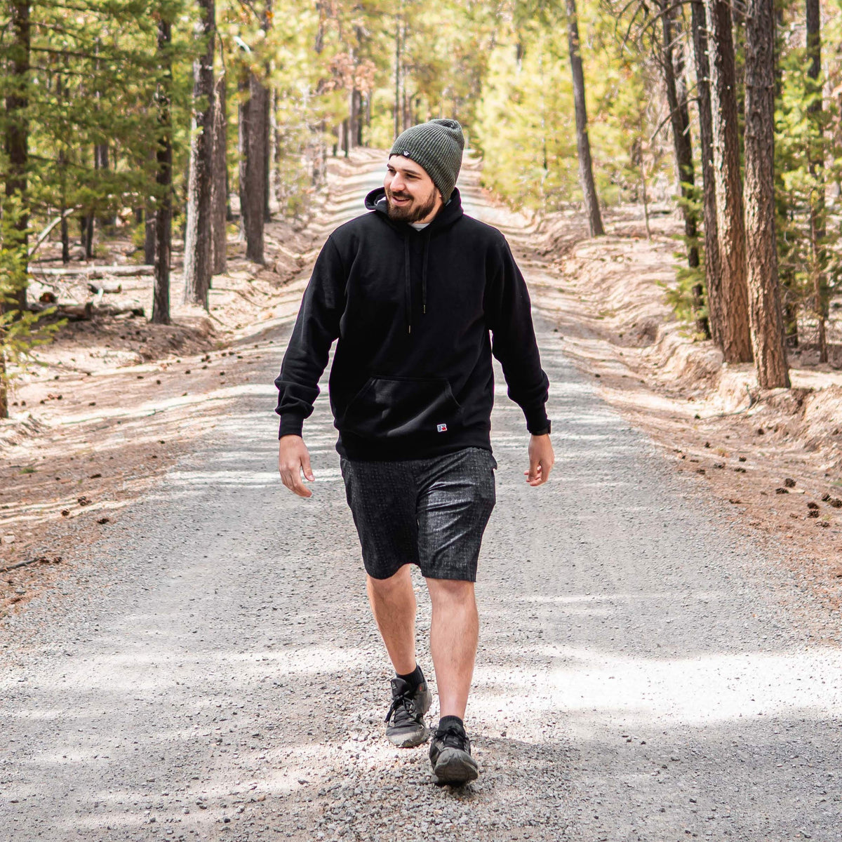 Tyler Barks walking along a forest road during an outdoor adventure