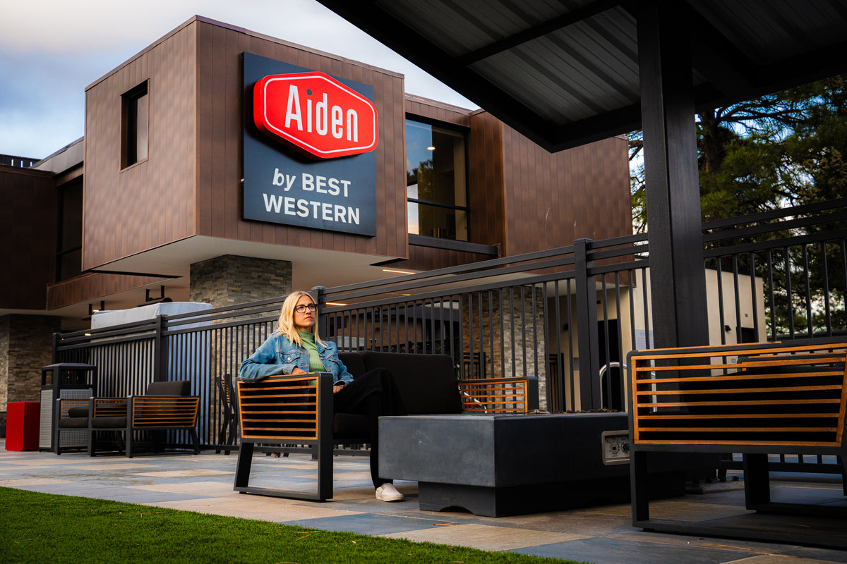 Guest seated outside the Aiden by Best Western property in Flagstaff, Arizona