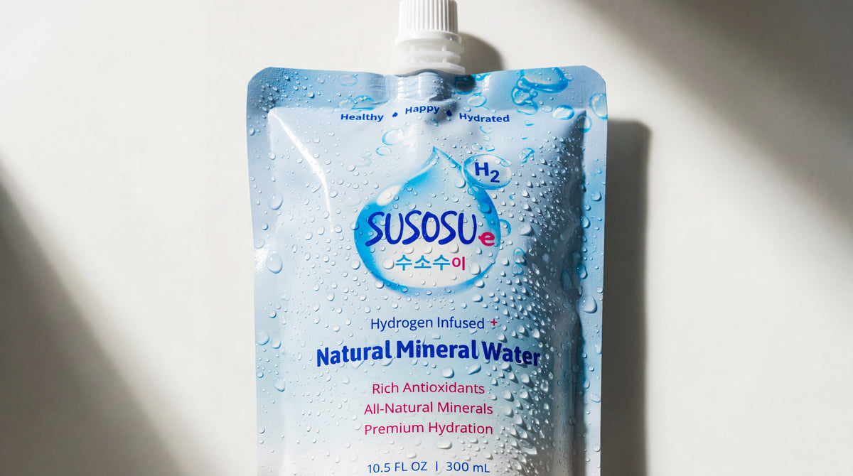 SUSOSU water pouch covered in water droplets on a light studio background with directional shadows