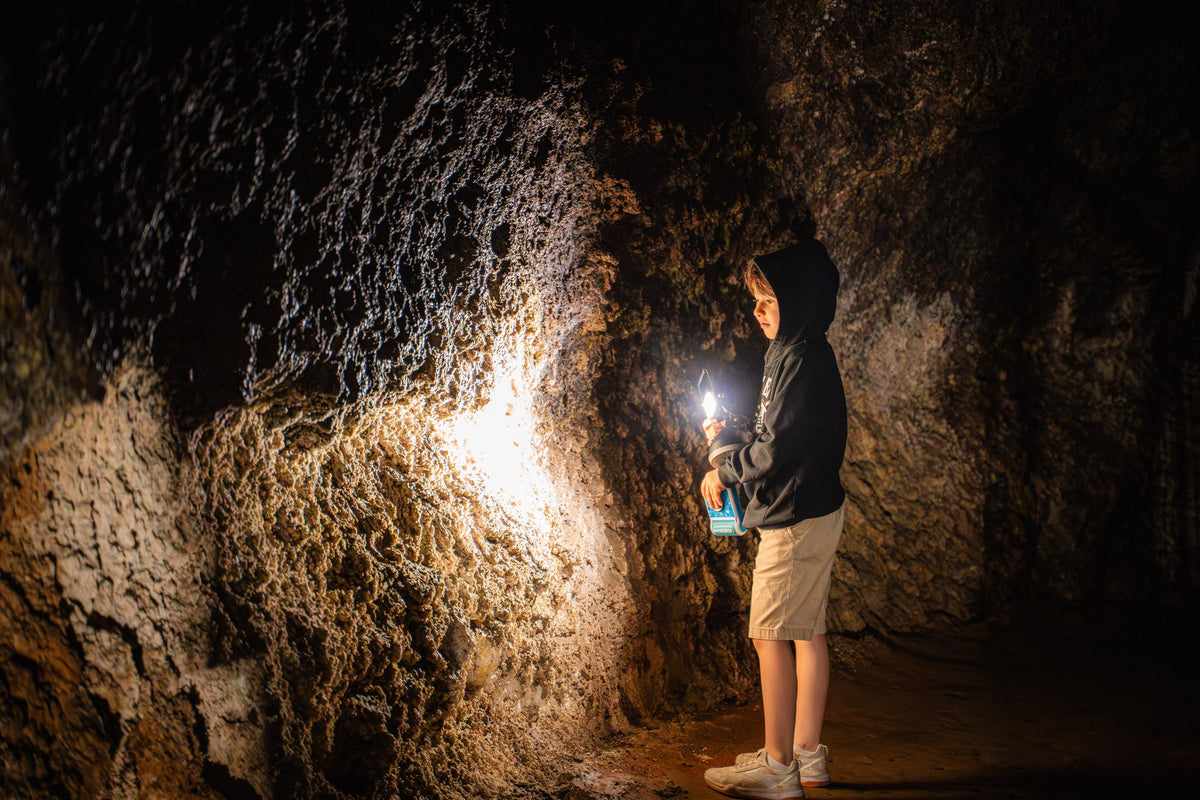 A child carrying a lantern inside Idaho's Mammoth Cave