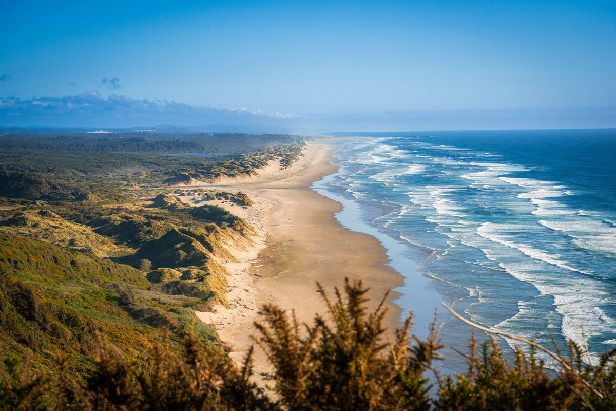 A broad sandy beach and waves along the Oregon coast