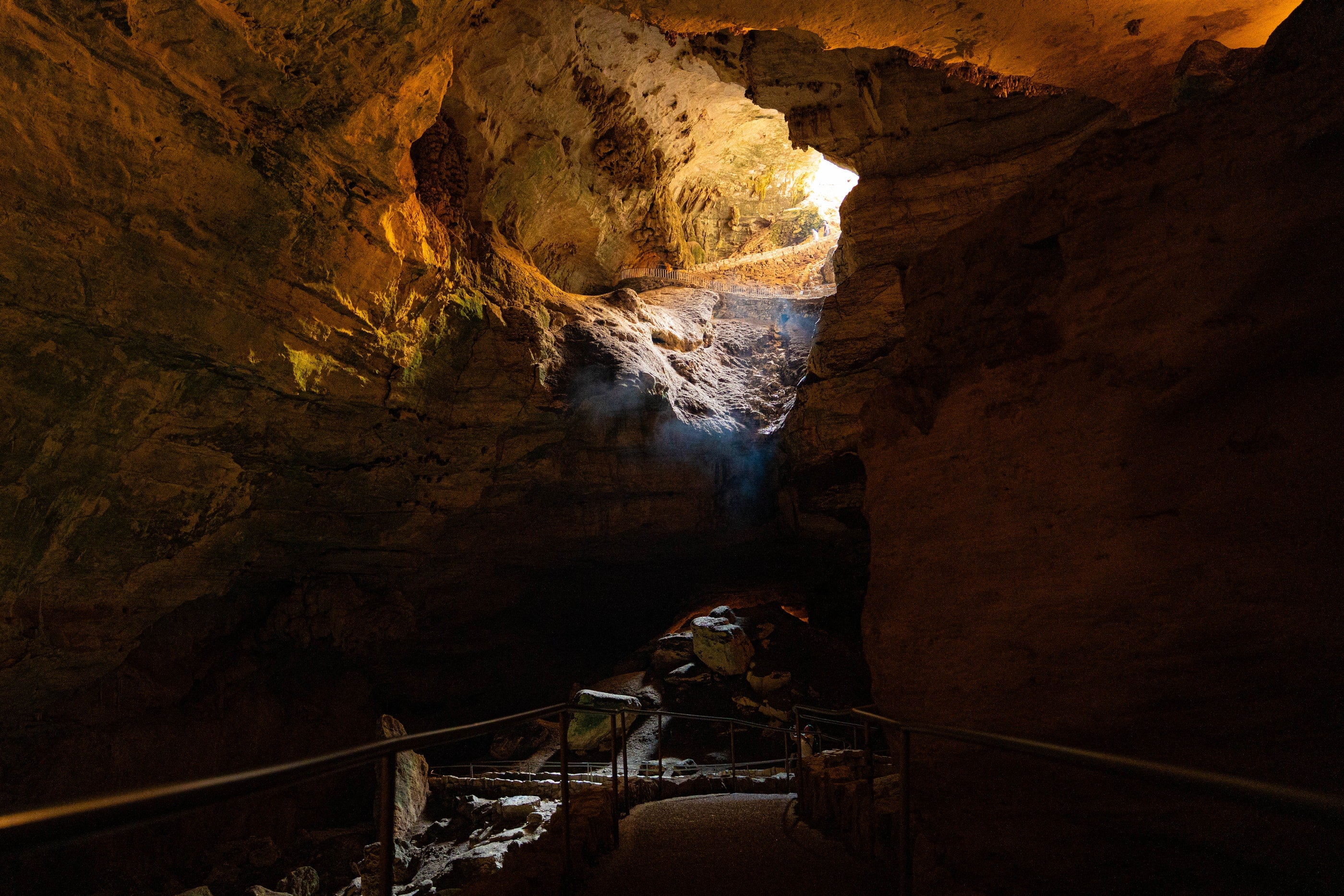 A lighted pathway and dramatic formations inside Carlsbad Caverns